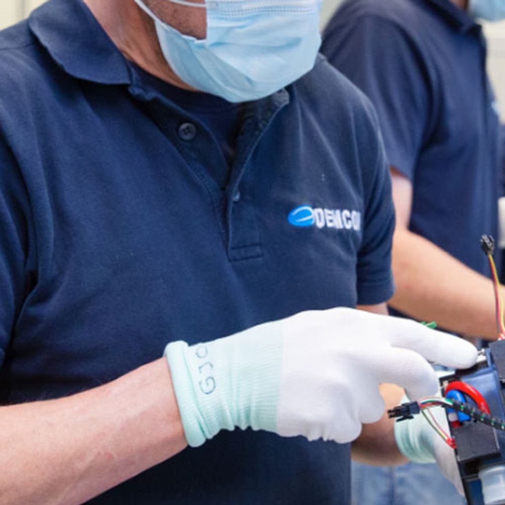 man in a mask with a little machine