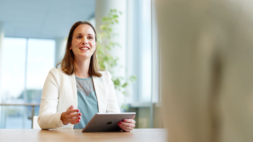 Demcon talking with ipad in hand