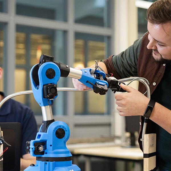 engineer working on robot arm