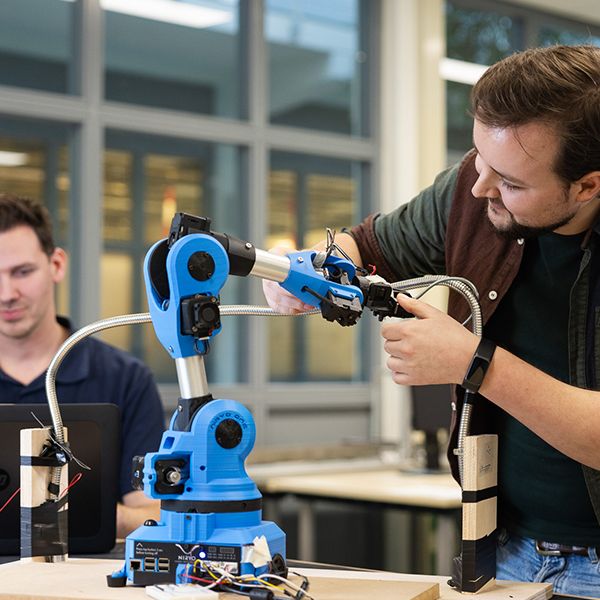 engineer working on robot arm